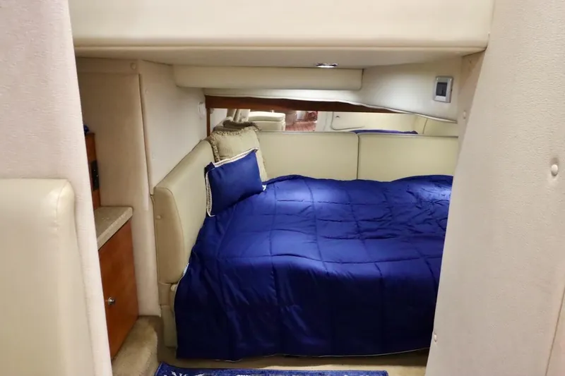 Pura Vida Yacht Photos Pics Interior cabin of 2006 Rinker 360 Express Cruiser with blue bedding.