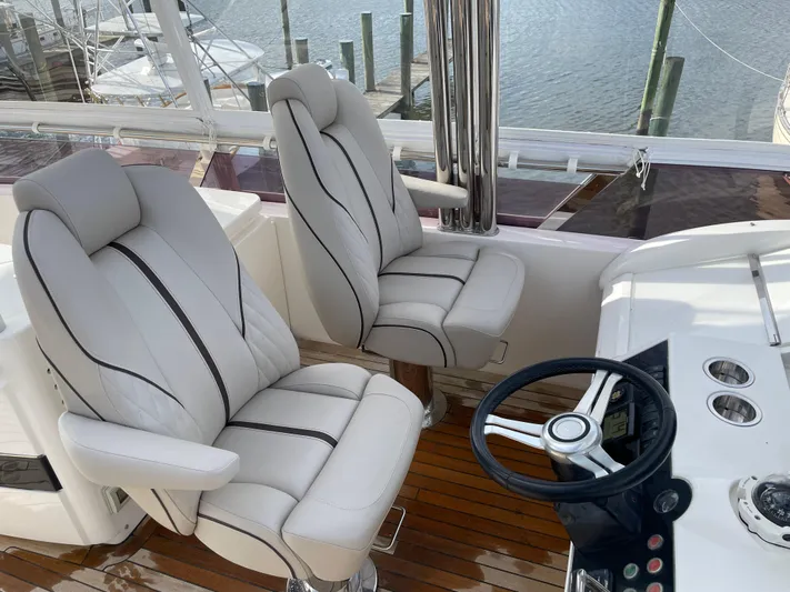  Yacht Photos Pics Luxurious helm seating on 2012 Princess 72 Motor Yacht with elegant design and wood flooring.
