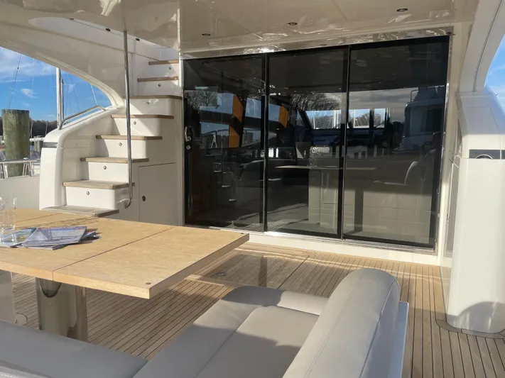  Yacht Photos Pics Luxurious 2012 Princess 72 Motor Yacht with elegant outdoor seating and sleek glass doors.