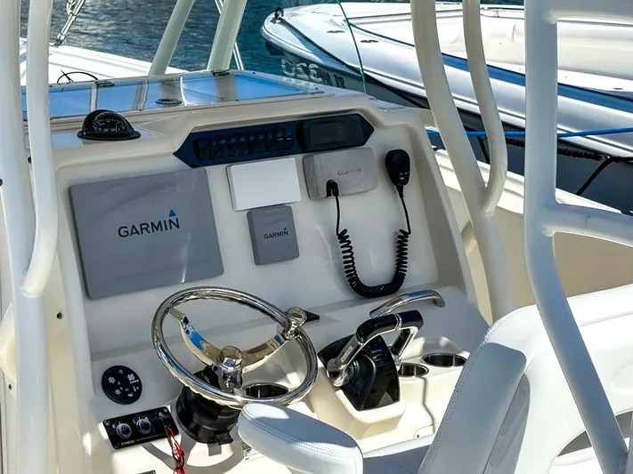  Yacht Photos Pics 2016 Sailfish 320CC boat console with Garmin navigation system and steering wheel.