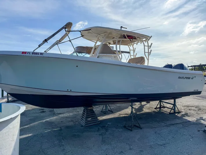  Yacht Photos Pics 2016 Sailfish 320CC boat on stands, side view, clear sky background.