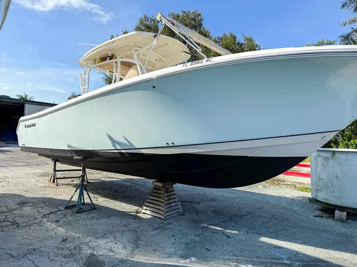  Yacht Photos Pics 2016 Sailfish 320CC boat on stands, white hull, outdoor setting.
