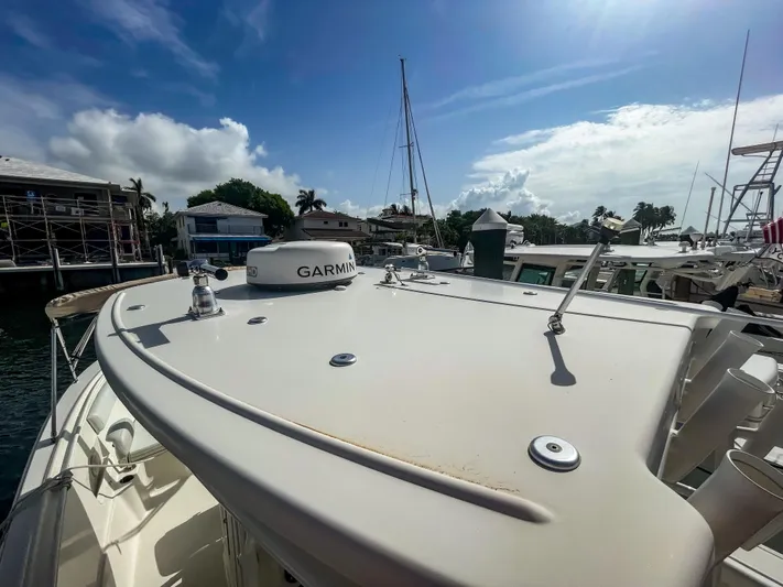  Yacht Photos Pics 2016 Sailfish 320CC boat docked, featuring Garmin equipment under a clear blue sky.