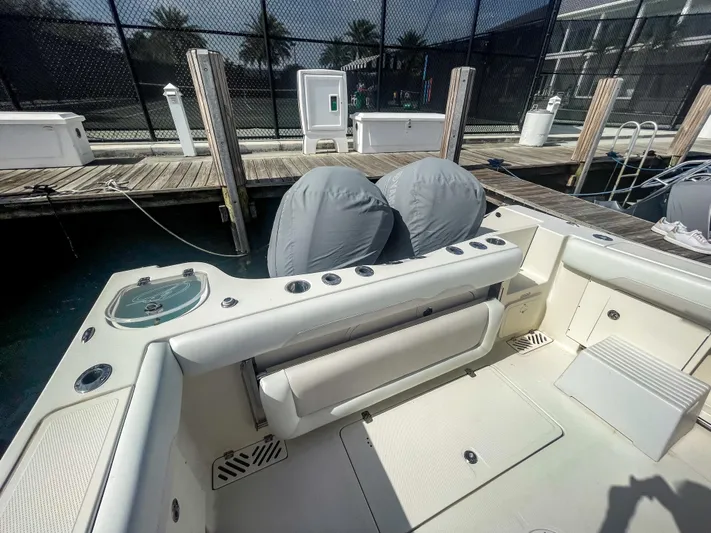  Yacht Photos Pics 2016 Sailfish 320CC boat interior at dock, featuring seating and storage areas.
