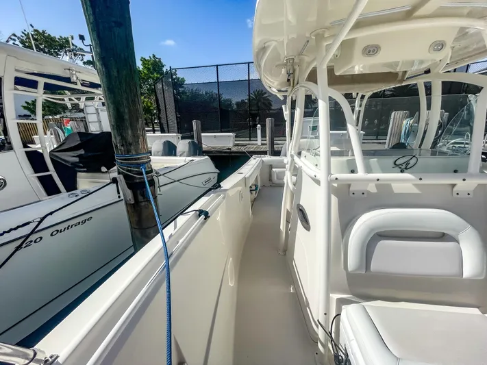  Yacht Photos Pics 2016 Sailfish 320CC boat docked, featuring sleek white design and spacious seating area.
