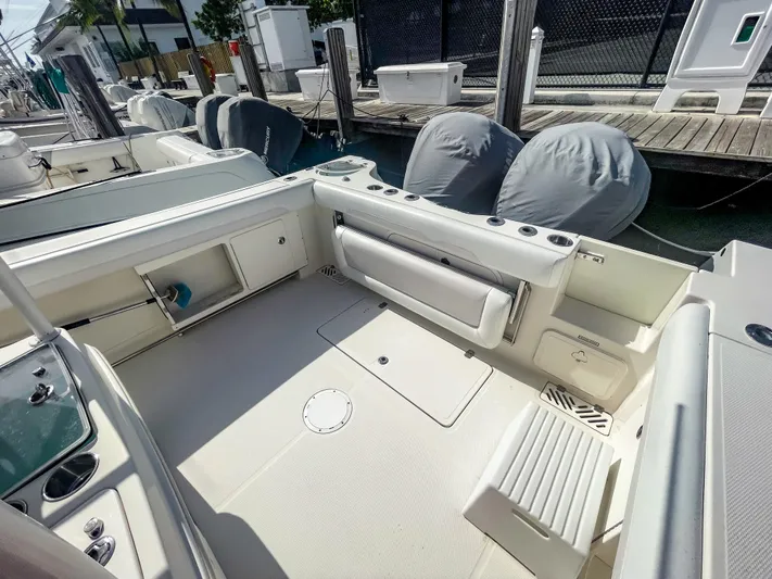  Yacht Photos Pics 2016 Sailfish 320CC boat interior with seating and storage at a marina.