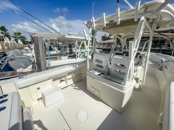  Yacht Photos Pics 2016 Sailfish 320CC boat interior with seating and fishing rod holders, docked at marina.