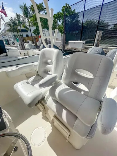  Yacht Photos Pics 2016 Sailfish 320CC boat with white cushioned seats and outdoor setting.