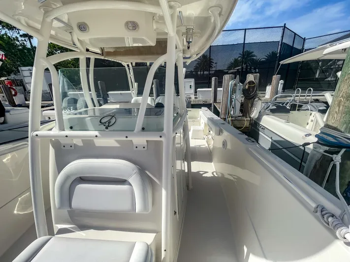  Yacht Photos Pics 2016 Sailfish 320CC boat interior with seating and helm, docked under clear skies.