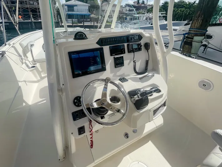  Yacht Photos Pics 2016 Sailfish 320CC boat helm with steering wheel, controls, and navigation equipment.