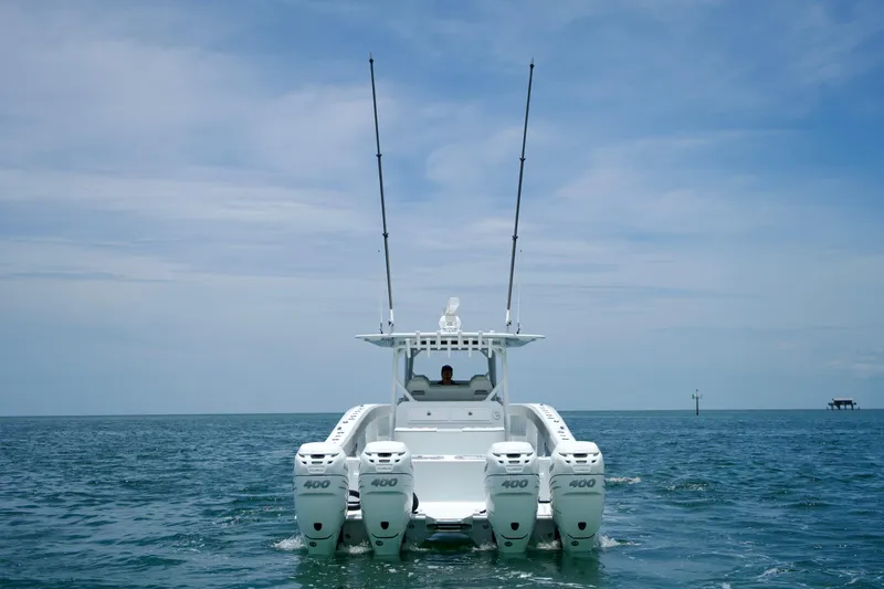  Yacht Photos Pics Freeman 42 LR 2022 boat with four engines on open water under blue sky.