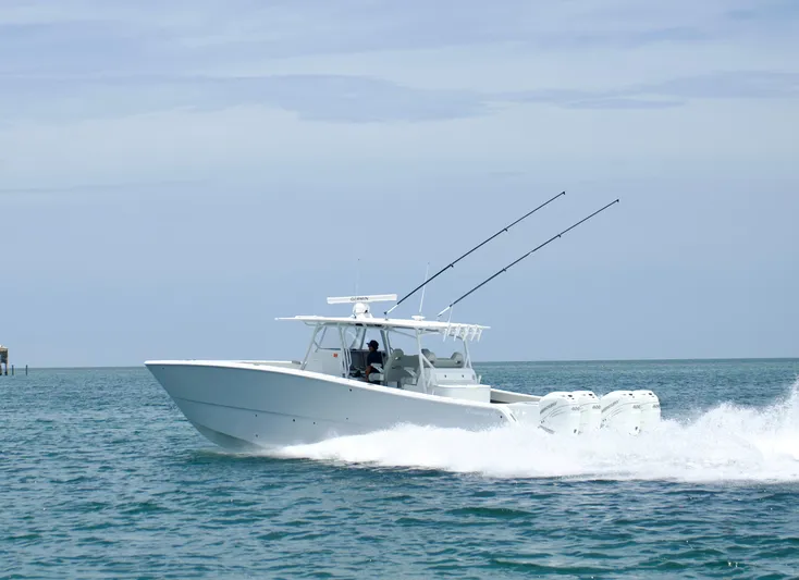  Yacht Photos Pics 2022 Freeman 42 LR boat cruising on open water with fishing rods.