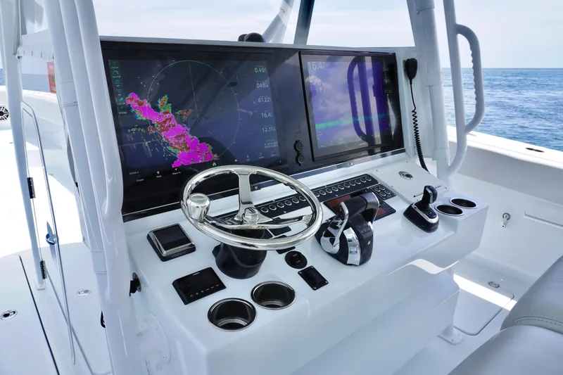  Yacht Photos Pics Freeman 42 LR 2022 boat dashboard with navigation screens and controls at sea.
