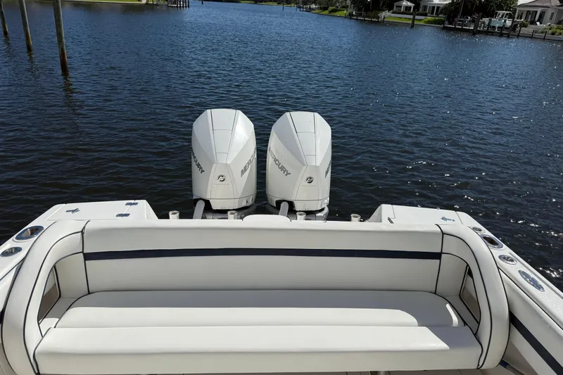  Yacht Photos Pics 2009 Intrepid 323 boat with dual Mercury engines on a calm waterway.