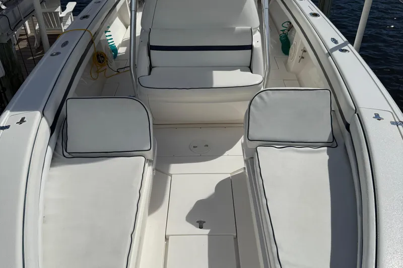  Yacht Photos Pics 2009 Intrepid 323 boat interior with white cushioned seating and deck.