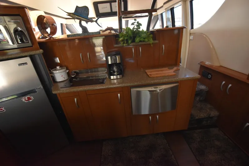 Seawood Yacht Photos Pics 2007 Carver 52 Voyager yacht kitchen with modern appliances and wooden cabinetry.