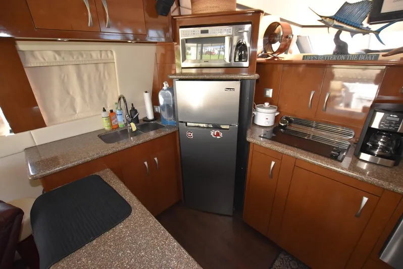 Seawood Yacht Photos Pics 2007 Carver 52 Voyager kitchen with modern appliances and wood cabinetry.