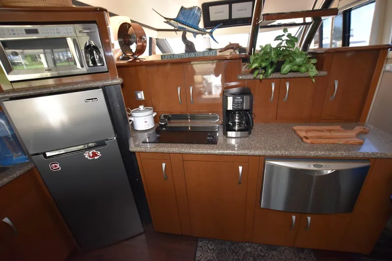 Seawood Yacht Photos Pics 2007 Carver 52 Voyager kitchen with modern appliances and wooden cabinetry.