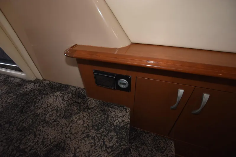 Seawood Yacht Photos Pics Interior of 2007 Carver 52 Voyager with wood cabinetry and patterned carpet.