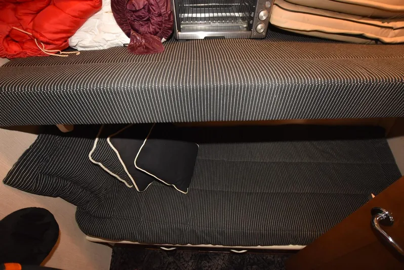 Seawood Yacht Photos Pics Interior of 2007 Carver 52 Voyager with striped cushions and compact storage.