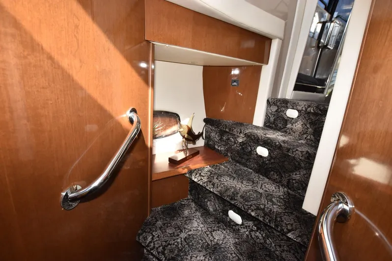 Seawood Yacht Photos Pics Interior stairs of 2007 Carver 52 Voyager yacht with elegant wood and carpet design.