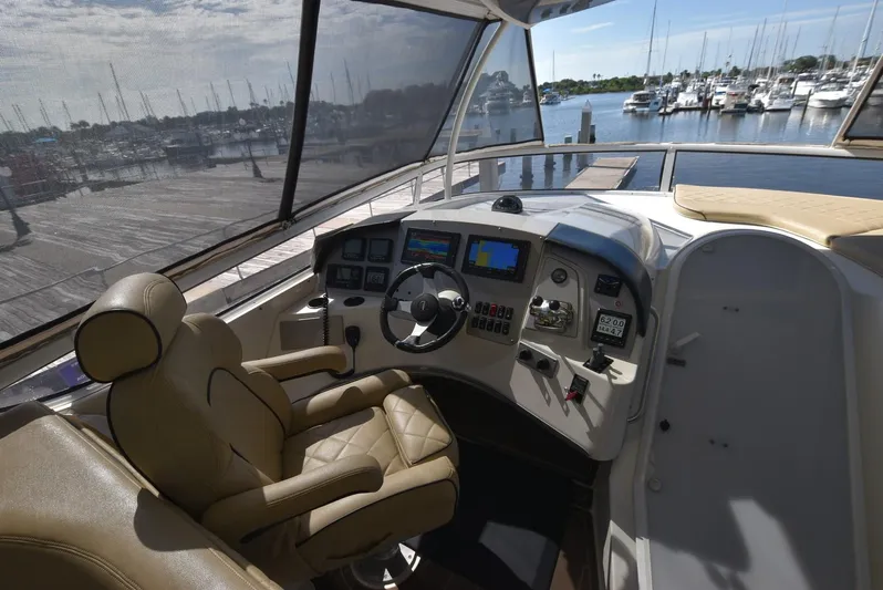 Seawood Yacht Photos Pics Interior helm of 2007 Carver 52 Voyager yacht with leather captain's chair and navigation controls.