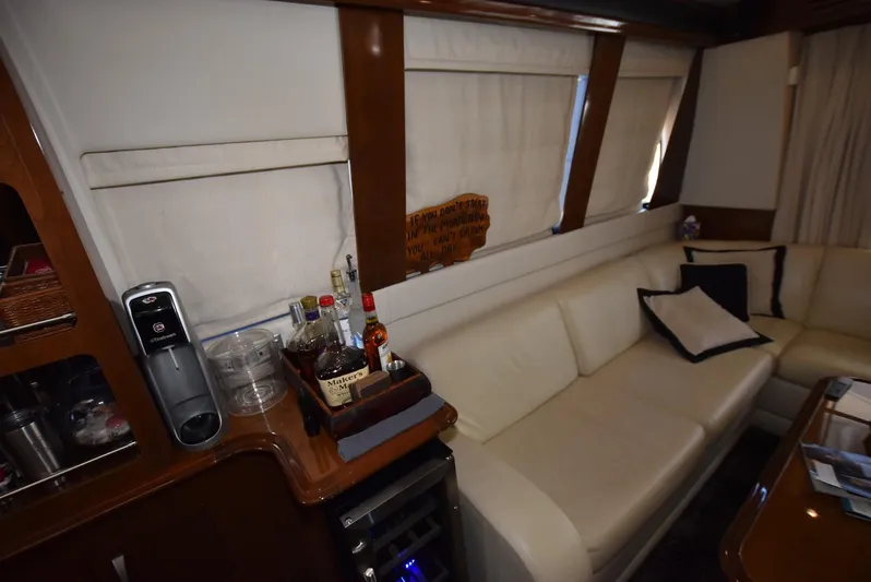 Seawood Yacht Photos Pics Interior of 2007 Carver 52 Voyager yacht with cream leather seating and mini bar setup.