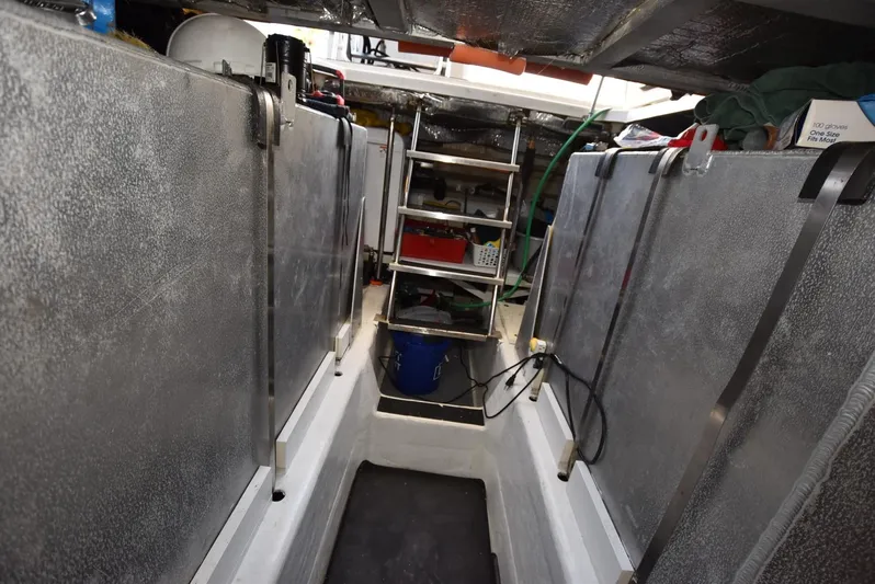 Seawood Yacht Photos Pics Engine room of 2007 Carver 52 Voyager yacht with metal panels and ladder.