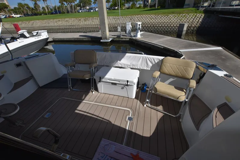 Seawood Yacht Photos Pics 2007 Carver 52 Voyager yacht deck with seating and cooler, docked at marina.