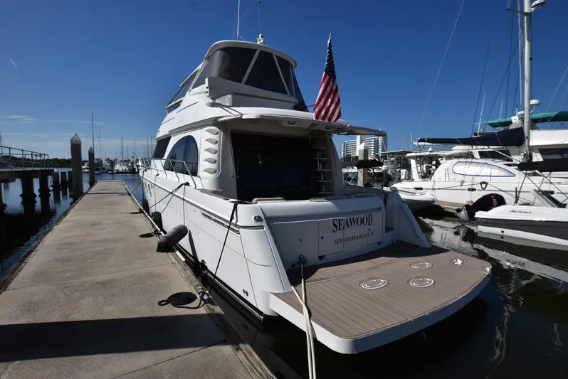 Seawood Yacht Photos Pics 2007 Carver 52 Voyager yacht docked at marina, rear view with American flag.