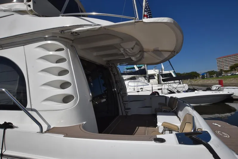 Seawood Yacht Photos Pics 2007 Carver 52 Voyager yacht docked at marina under clear blue sky.