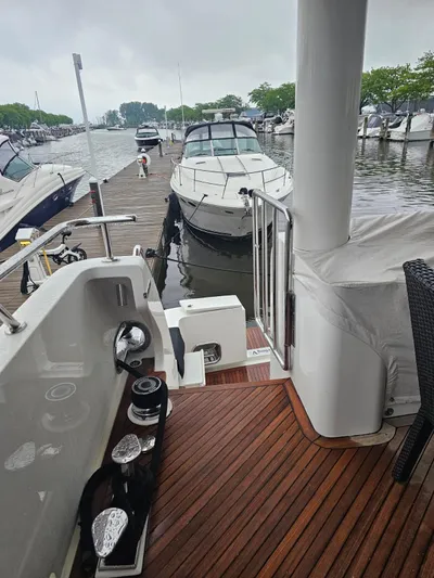 Sterling V Yacht Photos Pics 2007 Hargrave 93' yacht docked at marina with wooden deck and nearby boats.