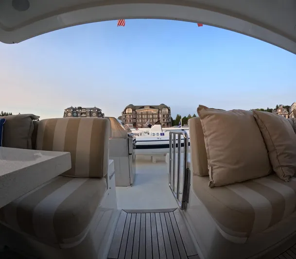 Sterling V Yacht Photos Pics Luxury yacht Hargrave 93' (2007) with plush seating, docked at a scenic marina.