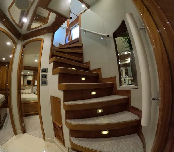 Sterling V Yacht Photos Pics Luxurious wooden staircase inside 2007 Hargrave 93' yacht, featuring elegant lighting and modern design.