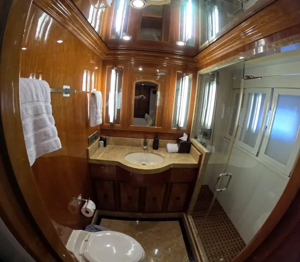 Sterling V Yacht Photos Pics Luxurious bathroom in 2007 Hargrave 93' yacht with wood paneling and modern fixtures.