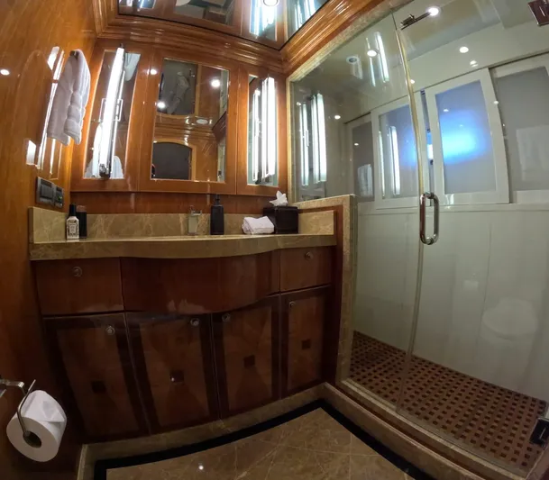 Sterling V Yacht Photos Pics Luxurious bathroom on 2007 Hargrave 93' yacht with glass shower and elegant wood finishes.