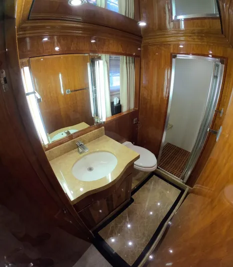 Sterling V Yacht Photos Pics Luxurious bathroom in 2007 Hargrave 93' yacht with wood accents and modern fixtures.