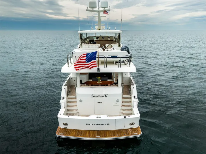 Sterling V Yacht Photos Pics Luxury Hargrave yacht, 93-foot model from 2007, cruising in open sea with American flag.
