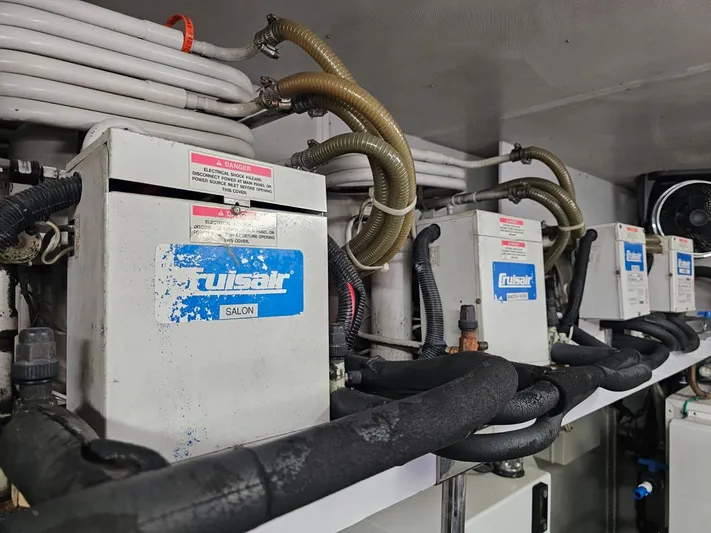 Sterling V Yacht Photos Pics Engine room equipment on a 2007 Hargrave 93' yacht, featuring multiple units and piping.