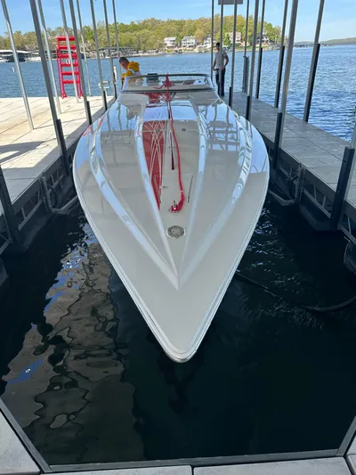 Yacht Photos Pics 2008 Fountain 38 Lightning speedboat docked in a marina, reflecting on calm water.