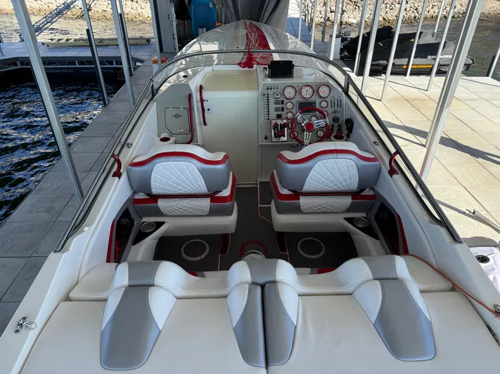  Yacht Photos Pics 2008 Fountain 38 Lightning boat interior with red and white seating and control panel.