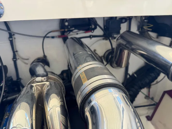  Yacht Photos Pics Engine components of a 2008 Fountain 38 Lightning boat, featuring polished metal pipes.