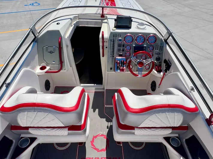  Yacht Photos Pics 2008 Fountain 38 Lightning boat interior with red and white seating, dashboard, and controls.