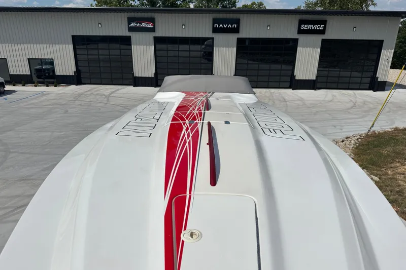  Yacht Photos Pics 2008 Fountain 38 Lightning boat with red and white design, parked outside a service building.