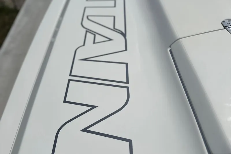  Yacht Photos Pics Close-up of 2008 Fountain 38 Lightning boat lettering on white surface.