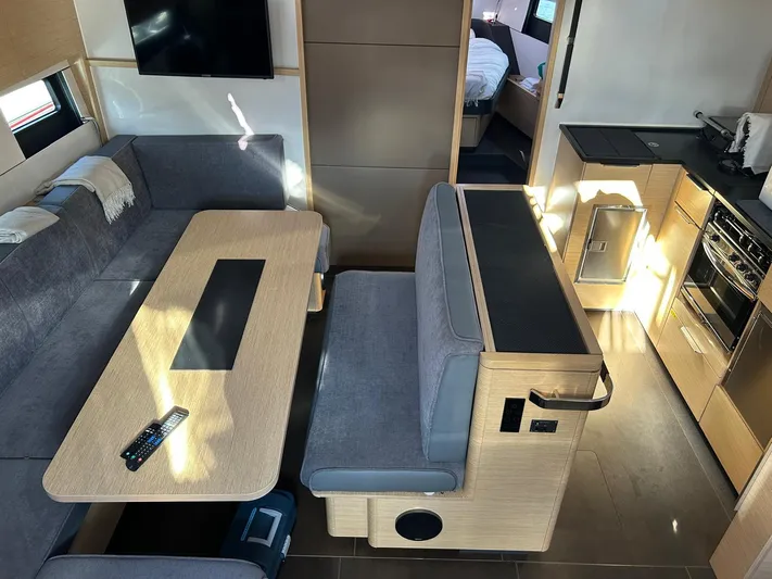  Yacht Photos Pics Modern interior of 2022 Hanse 510 yacht with dining area and kitchen.