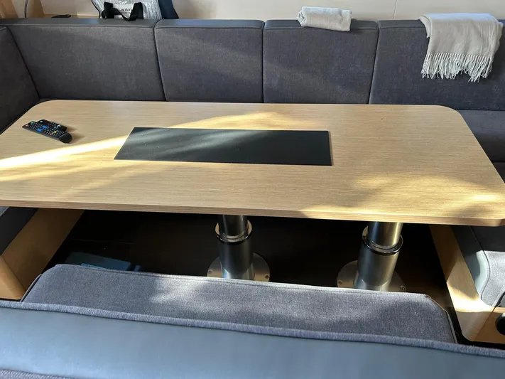  Yacht Photos Pics Modern yacht interior with a wooden table and gray seating, Hanse 510, 2022 model.