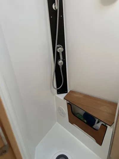  Yacht Photos Pics Shower area in 2022 Hanse 510 yacht with modern fixtures and wooden storage.