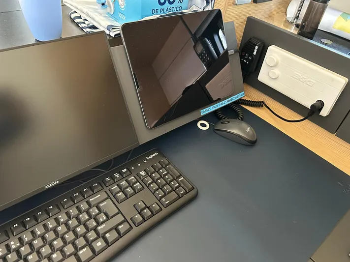  Yacht Photos Pics Modern office setup with keyboard, monitor, tablet, and electronic device on a Hanse 510, 2022.