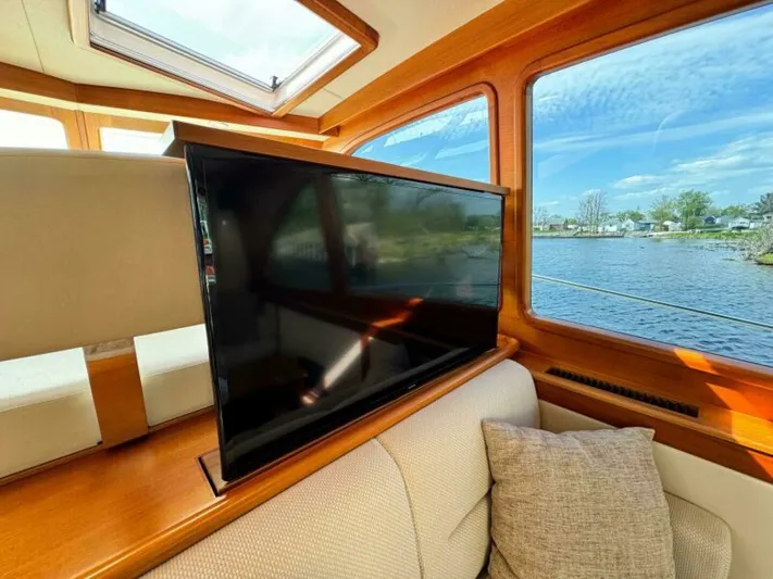 Castlefinn Yacht Photos Pics Luxurious interior of 2018 Palm Beach Motor Yachts PB55 with pop-up TV and scenic water view.
